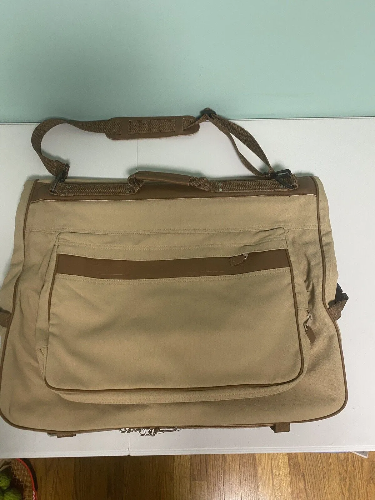 Angled front view with bag zipped and handles upright.